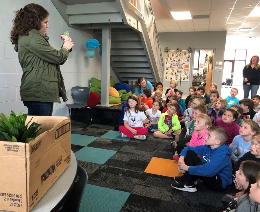 MORE LEARNING FUN IN FIRST GRADE!  Kendra Hickey, a student from the Warren County Career Centers Veterinary Science Program, came to teach first grade students about chameleons. First graders learned about reptiles and got to see firsthand what one looks like and how it uses its tongue to eat. Students listened to a story about how chameleons' mood can change their color and tail shape. Stormy, the chameleon, got a little nervous and started to turn a dull green and she straightened her tail. Stormy performed well and showed students how she snaps her tongue in and out to catch food. Thank you so much Miss Hickey for the amazing experience. 